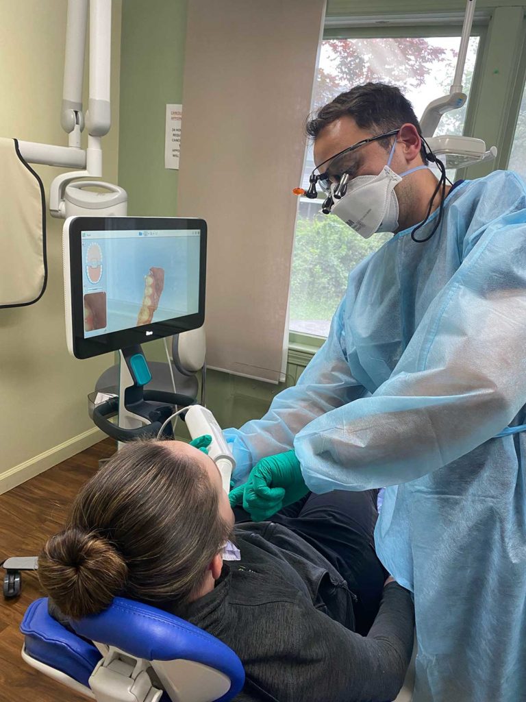 a dentist uses an itero digital intraoral scanner to create a 3d model of a patient's teeth