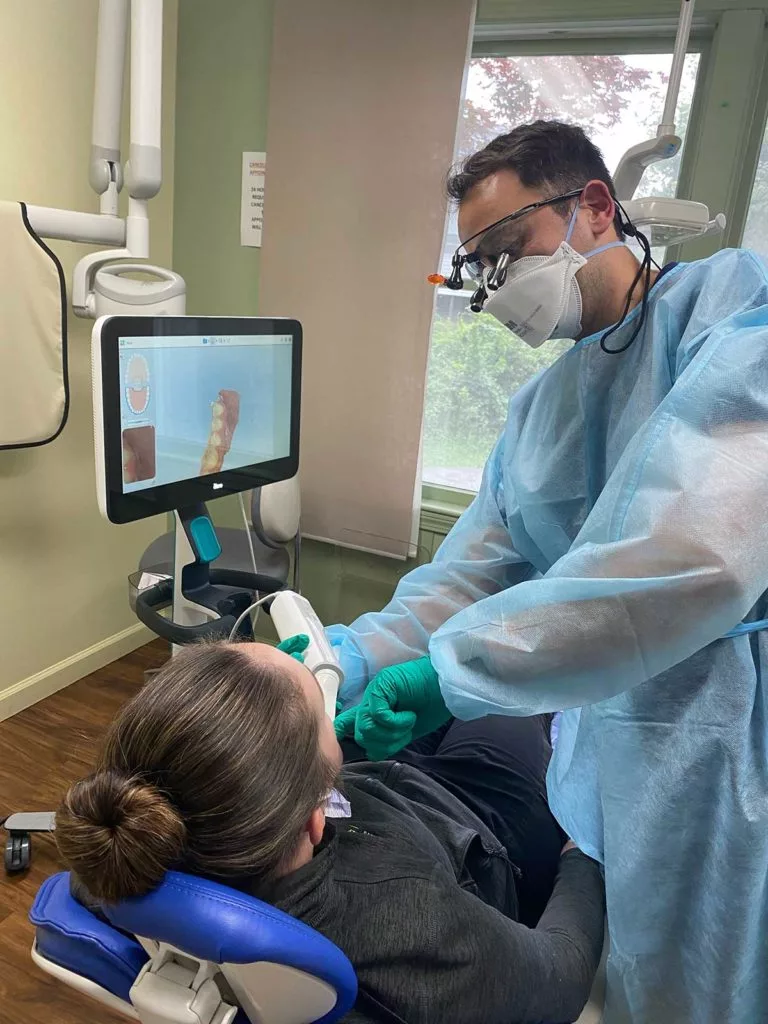 a dentist uses an itero digital intraoral scanner to create a 3d model of a patient's teeth